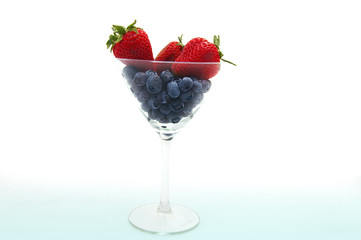 fresh strawberries and blueberries in martini glass