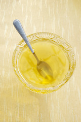 bowl with honey and spoon on table with selective focus