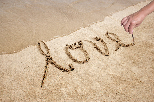 Love handwritten in sand for natural