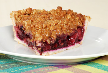 closeup slice of fruit berry crumble pie