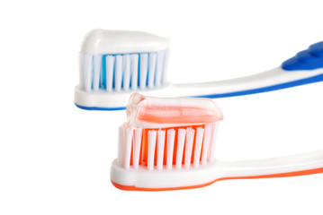 two toothbrushes with paste