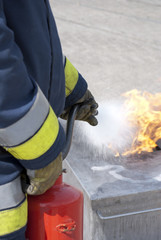 Firefighter using fire extinguisher