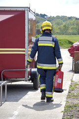 Firefighter carrying fire extinguisher