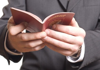 men's hand showing  passport in a customs control