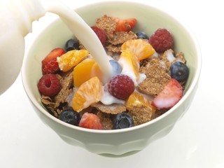Pouring Milk onto Cereal with Fresh Fruit