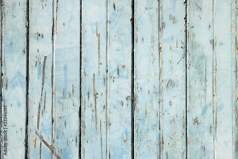 Wall mural Old weathered light blue painted fence close up.