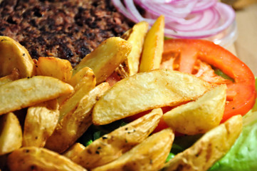 Burger with french fries, tomato and onions. Fast food.