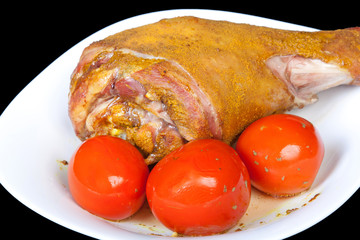Roasted turkey leg with tomatoes