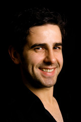Obraz premium Portrait of young attractive man on a black background