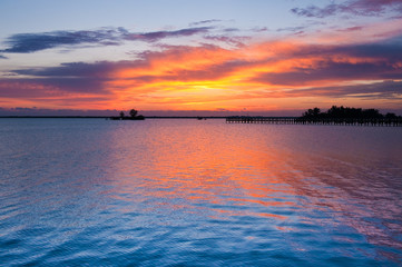 Dramatic sky before sunrise in golden colors on Indian river - 23349306