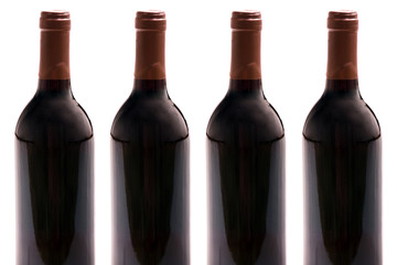 Four wine bottles isolated on white background, studio shot