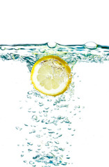 Sliced lemon splash in water