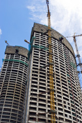 Skyscraper building on a background of the blue sky
