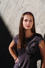 Fashion model by the concrete wall