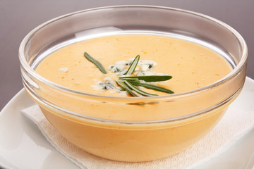 Bowl of hot delicious pumpkin soup with blue cheese