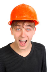 amazed teenager in old and damaged hard hat