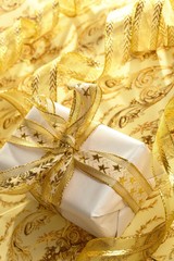 Beautiful gift box on the gold background