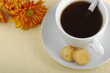 Blacktea with biscuits and orange flower (Selective Focus)