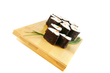 rolls of sushi on wood