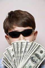 Money Man.Boy holding a fan of one hundred dollar bills