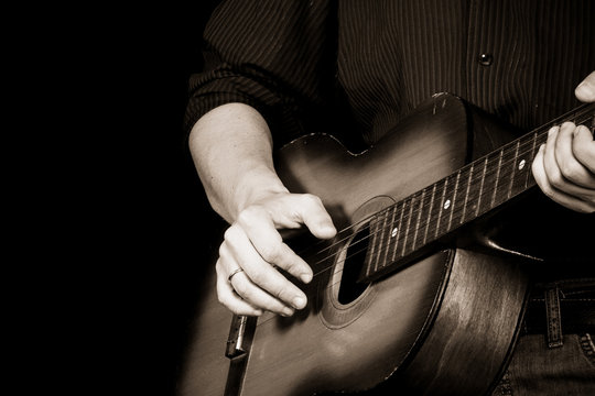 sepia image of man and guitar