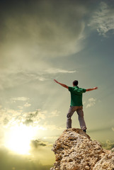 Man on peak of mountain