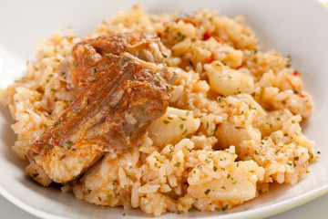 rice dish with potatoes and pork chops