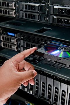 Technician Inserting CD-Rom into server