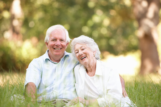 Senior Couple Sitting In Park