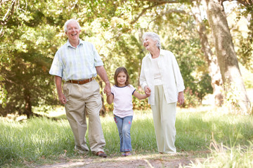 Naklejka na ściany i meble Grandparents In Park With Granddaughter