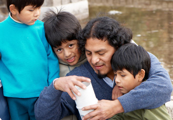 Fototapeta premium Latin family sitting in the street