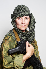 Portrait of the woman of the soldier with an automatic assault r