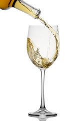 White wine poured in a glass isolated on a white background