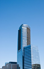 Fototapeta na wymiar Round Blue Tower by Square Blue Office