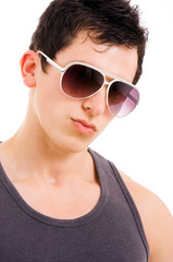 Portrait of stylished young man wearing sunglasses on white back