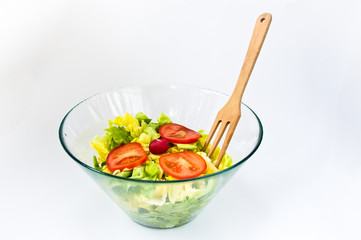 Bowl of salad with wooden spoon