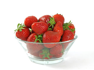 fresh and juicy strawberries on glass bowl over white