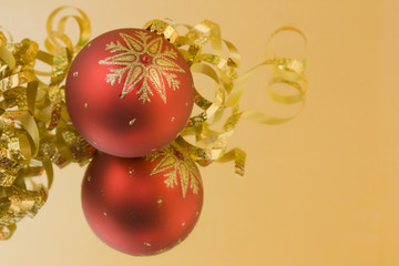 red bauble soft gold background