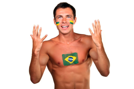 Portrait of a brazilian fan with flag on his body and face
