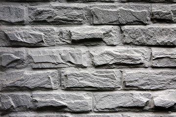 close-up of old wall from gray brick .