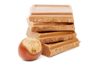 Chocolate and hazelnuts on white background