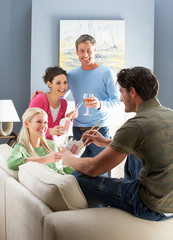 Group Of  Friends Enjoying Chinese Takeaway Meal At Home