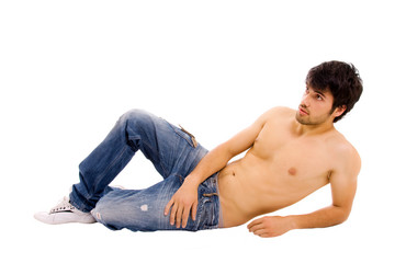 Obraz premium Young sensual man lying on the floor, studio shot