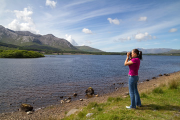 Photographer women in Connemara mountains terrain