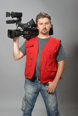 Cameraman in red vest, shows gesture