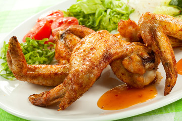 Grilled chicken wings with vegetable salad