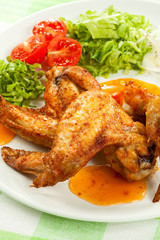 Grilled chicken wings with vegetable salad