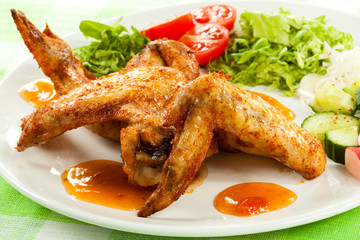 Grilled chicken wings with vegetable salad