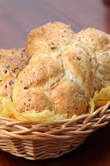Basket with fresh buns on a wooden table