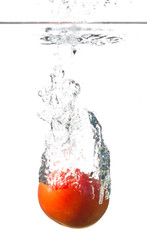 tomato splashing into water isolated on white background